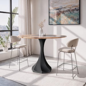 May include: A round wooden bar table with a black geometric base. Two beige upholstered bar stools with metal frames are positioned on either side of the table. The table is approximately 42 inches in diameter.