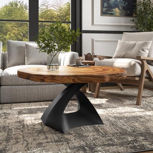 May include: A wooden coffee table with a natural wood top and a black metal base. The base is shaped like a twisted X. The table is sitting on a rug in a living room.