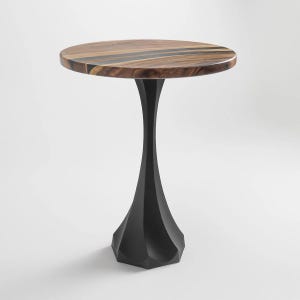 May include: A round side table with a dark wood top and a black geometric base. The tabletop features a natural wood grain pattern. The table stands approximately 24 inches tall.