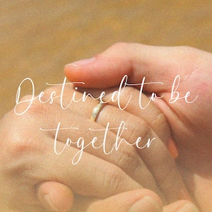 May include: Two hands holding each other with a gold wedding band on one finger. The text "Destined to be together" is written in white cursive script.