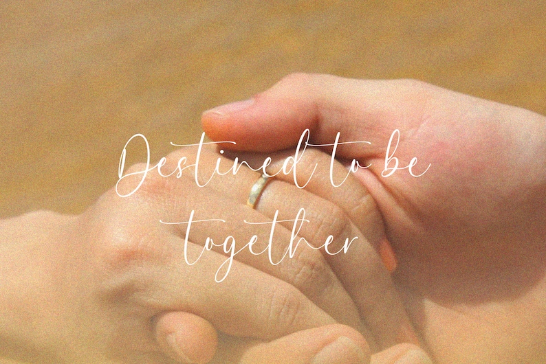 May include: Two hands holding each other with a gold wedding band on one finger. The text "Destined to be together" is written in white cursive script.