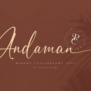 May include: A modern calligraphy font called "Andaman" by Penculture. The font is displayed in a cursive style with a brown background and a subtle leaf shadow.