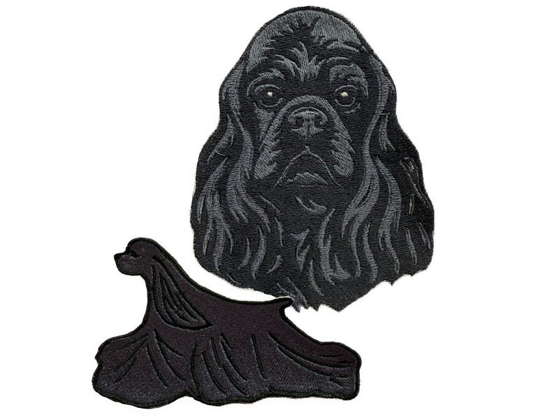 May include: Two black embroidered patches depicting a Cocker Spaniel. One is a detailed head portrait, the other shows the dog's body in a stylized pose. These patches are designed for sewing or ironing onto fabric.