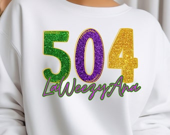 May include: White sweatshirt with a green, purple, and gold glitter design that says "504 LaWeezy Ana".
