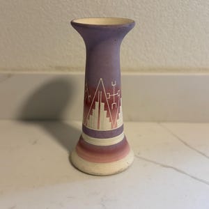 May include: A distressed wooden sign with the words "Welcome to our home" in white lettering. The sign has a rustic finish, ideal for a front porch or hallway, creating a welcoming atmosphere.