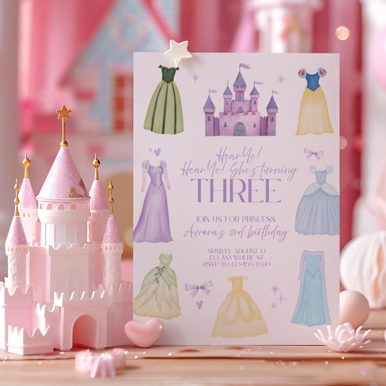 May include: A pink and white princess-themed birthday invitation with a castle and dress illustrations. The invitation reads "Hear Me! She's turning THREE" and includes party details. A pink castle model is in the foreground.