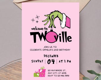 May include: A pink birthday invitation with the words "welcome to TWOville" and a green hand holding a pink bauble. The invitation includes the date, time, and location of the party.