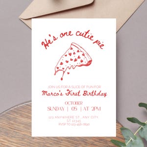 May include: A white invitation with red text and a red illustration of a pizza slice with hearts. The text reads "He's one cutie pie" and "Marco's First Birthday". The invitation includes the date, time, and RSVP information.