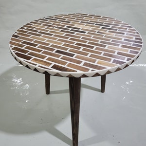 The small Moroccan table made of walnut wood and white resin is a unique piece of art.