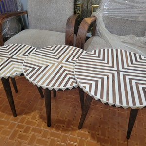 Three tiered tables made of walnut wood and resin. An elegant round table