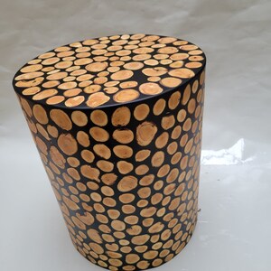 A round table made of olive wood and resin, an elegant table in black