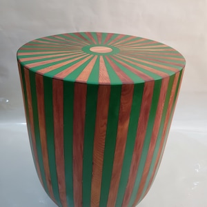 Round table made of cedar wood and resin. Striped table
