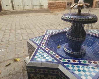 Mosaic fountain The outdoor and indoor fountain inside a large Moroccan mosaic fountain.Moroccan fountain