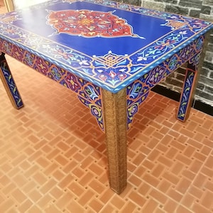 Moroccan table decorated with Moroccan motifs in copper-plated colors and legs