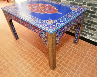 Moroccan table decorated with Moroccan motifs in copper-plated colors and legs