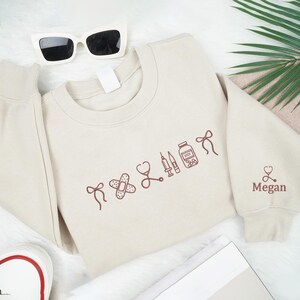Embroidered Custom Name Nurse Icon Sweatshirt, Gifts For Nurse, Cute Medical Icon Crewneck, Healthcare Apparel For Nurse, Appreciation Gift