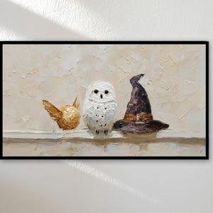 May include: Oil painting of a golden snitch, a white owl, and a witch's hat. The artwork is set against a textured, off-white background and is framed in black. The painting evokes a whimsical, fantasy theme.