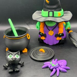 May include: A collection of Halloween-themed figurines, including a witch with a black hat, green face, and purple dress, a cauldron, a black cat, a spider, and a cauldron lid. The witch has orange braids and is holding a broom.
