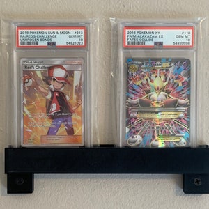 ¡Soporte de pared para 2 cartas para deportes, Pokémon y otros TCG! Se adapta a todas las tarjetas graduadas, paquetes, cargadores superiores, soportes magnéticos y mucho más. ¡Soporte de pared universal!