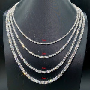 May include: Five different sizes of tennis chain necklaces, ranging from 3mm to 5mm in width. The necklaces are made of silver and are adorned with sparkling cubic zirconia stones.