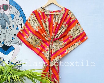 May include: A long, orange and pink striped kaftan with a tiger print. The kaftan has a V-neck and is tied at the waist.