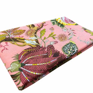 May include: Pink fabric with a floral print featuring large pink flowers, green leaves, and brown branches.