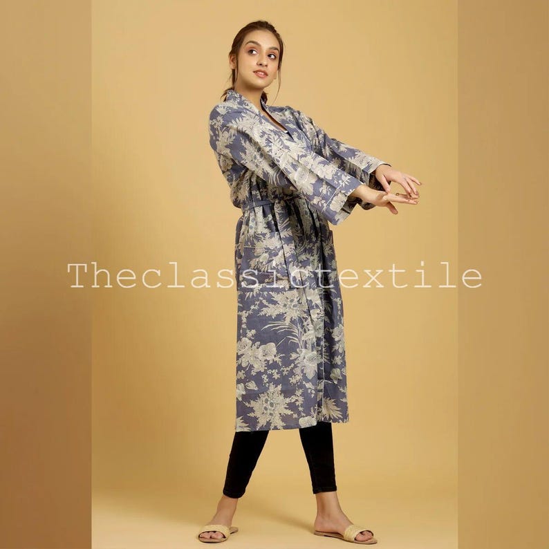May include: A long, blue floral print robe with a tie belt. The robe has a relaxed fit and long sleeves.