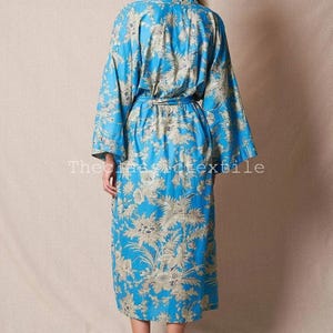 May include: A long, blue floral print robe with a tie belt. The robe is in a traditional Japanese kimono style.