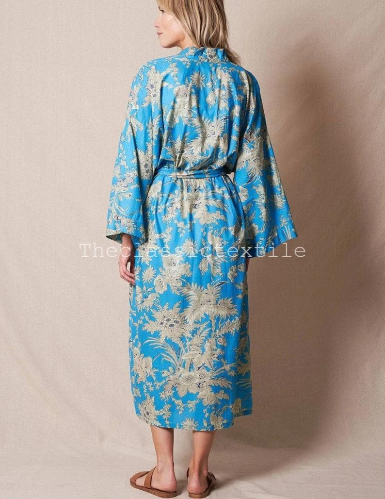 May include: A long, blue floral print robe with a tie belt. The robe is in a traditional Japanese kimono style.