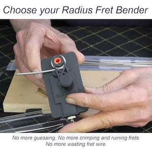 May include: A black guitar fret bender tool with an orange center adjustment knob and a lever arm. The device features the text 'Six Stringers' embossed on the body. The text 'Choose your Radius Fret Bender' and 'No more guessing. No more crimping and ruining frets. No more wasting fret wire.' is visible.