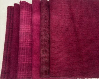 May include: A set of six fabric scraps in various shades of burgundy. The fabrics have different textures, including a plaid, a solid, and a burlap.