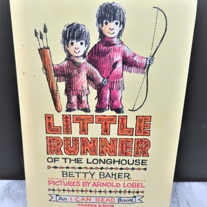 May include: A vintage children's book cover featuring two Native American children, one holding a bow and arrow and the other holding a quiver of arrows. The book title is "Little Runner of the Longhouse" by Betty Baker with illustrations by Arnold Lobel. It is an "I Can Read Book" published by Harper & Row.