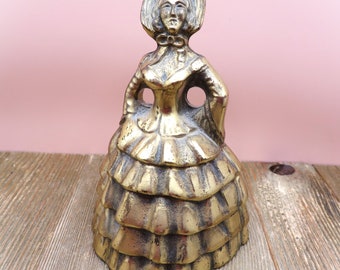 Vintage brass lady bell figurine.