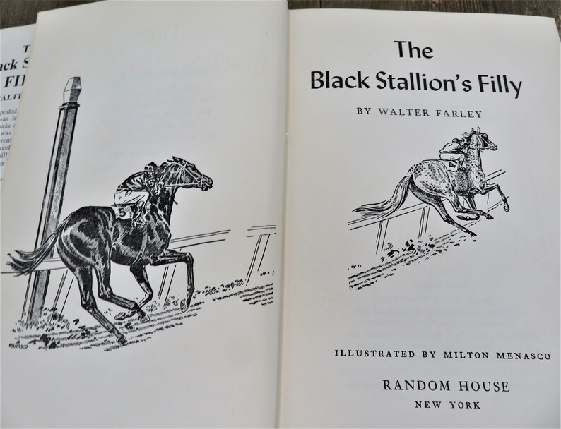 Puede incluir: Una ilustraci&oacute;n en blanco y negro de un caballo corriendo en una pista. El texto de la portada del libro dice "The Black Stallion's Filly" de Walter Farley. El libro est&aacute; ilustrado por Milton Menasco y publicado por Random House.