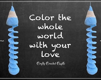 May include: Two blue and white crocheted spiral hanging ornaments with the text "Color the whole world with your love" and "Crafty Crochet Castle" written in white chalk on a black chalkboard background.