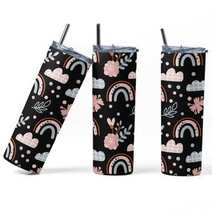 May include: Three black insulated tumblers with a rainbow, cloud, and floral pattern. The design includes pink, orange, and blue elements. Each tumbler has a silver straw and a black lid. The tumblers are designed to keep drinks cold or hot.