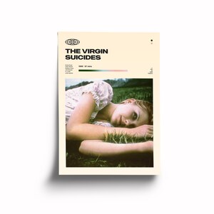 May include: A movie poster for the film "The Virgin Suicides" featuring a young woman lying in a field of grass. The poster is in a vintage style with a cream background and black text.