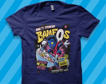 May include: A navy blue t-shirt with a cartoon illustration of a blue superhero character holding a spoon and standing in a bowl of cereal. The cereal box is labeled "Kurt's Krunchy Bamfos" and features the text "Free Inside! (Collector's Edition Sword)" and "Teleporting to your taste buds since 1975!"
