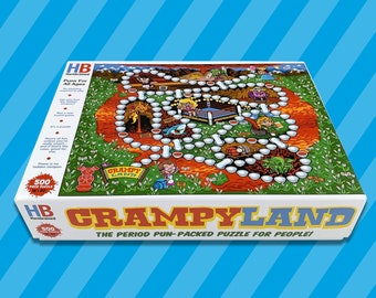 以下が含まれることがあります： カラフルなゲームボードのイラストが描かれた、500ピースのジグソーパズルボックス。ボックスは青と白で、「Crampyland: The Period Pun-Packed Puzzle for People!」の文字が印刷されています。