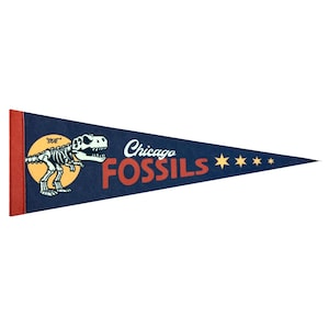 May include: A blue pennant with a red border and white text that reads "Chicago Fossils". A cartoon dinosaur skeleton is on the left side of the pennant with the text "Sue" above it. There are five yellow stars on the right side of the pennant.