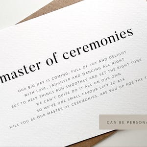 May include: A white card with the words "master of ceremonies" in a bold, black font. The card includes additional text below, asking someone to be the master of ceremonies. The card is on a brown envelope.