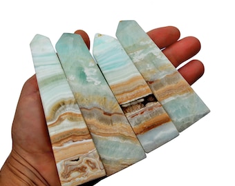 May include: Five blue and brown banded aragonite crystal points, also known as blue calcite, arranged in a fan shape. The points are polished and have a smooth, glassy finish.