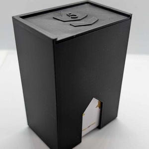 May include: Black plastic card storage box with a number "3" on the top. The box has a slot on the side to view the cards inside.