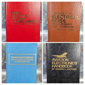 May include: Four hardcover handbooks with gold lettering. Titles include "The Active Filter Handbook", "Handbook of Electrical Noise", "Microprocessors", and "Aviation Electronics Handbook". The books are red, orange, blue, and black.