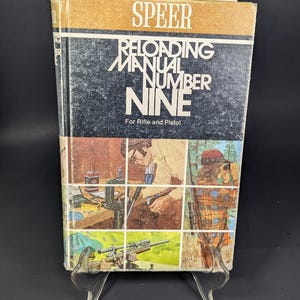 May include: Speer Reloading Manual Number Nine for Rifle and Pistol. The book has a black and white cover with the title in large white letters. The cover features illustrations of people reloading ammunition.