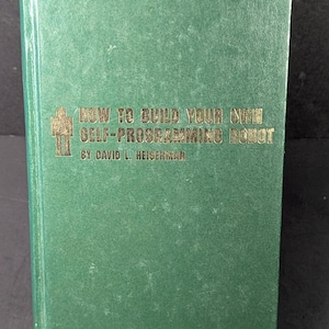 May include: A green book with the title "How to Build Your Own Self-Programming Robot" by David L. Heiserman.
