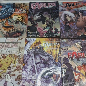 May include: A collection of six "Fables" comic books. The covers feature various illustrations, including a tiger, a wolf, and figures in different settings. The titles include "Animal Farm," "Storybook Love," and "Arabian Nights (and Days)."