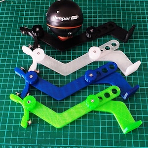 May include: Four 3D printed fishing rod holders in black, white, blue, and green. Each holder has a knob to adjust the angle. The holders are designed to hold a sonar device, such as the "deeper pro+" sonar device shown in the image.