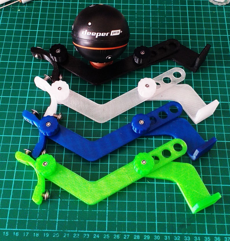 May include: Four 3D printed fishing rod holders in black, white, blue, and green. Each holder has a knob to adjust the angle. The holders are designed to hold a sonar device, such as the "deeper pro+" sonar device shown in the image.
