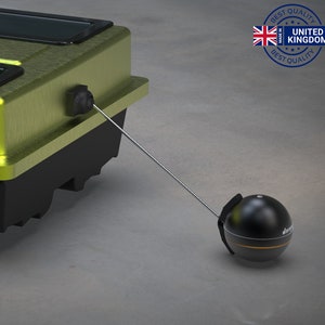 May include: A green and black fishing boat with a black and gold fish finder attached to a long cable.